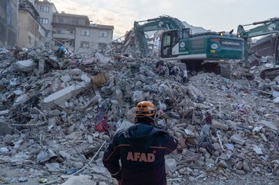 A rescue worker AFAD near the rubble of a collapsed residential building in Hatay on Sunday. Bloomberg