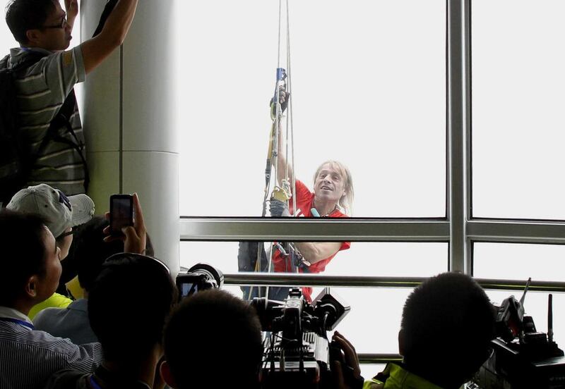 The ‘French Spiderman’ Alain Robert climbs the 388-metre Central Plains Fortaleza tower in Zhengzhou, central China’s Henan province in about two hours on September 22, 2012. AFP Photo