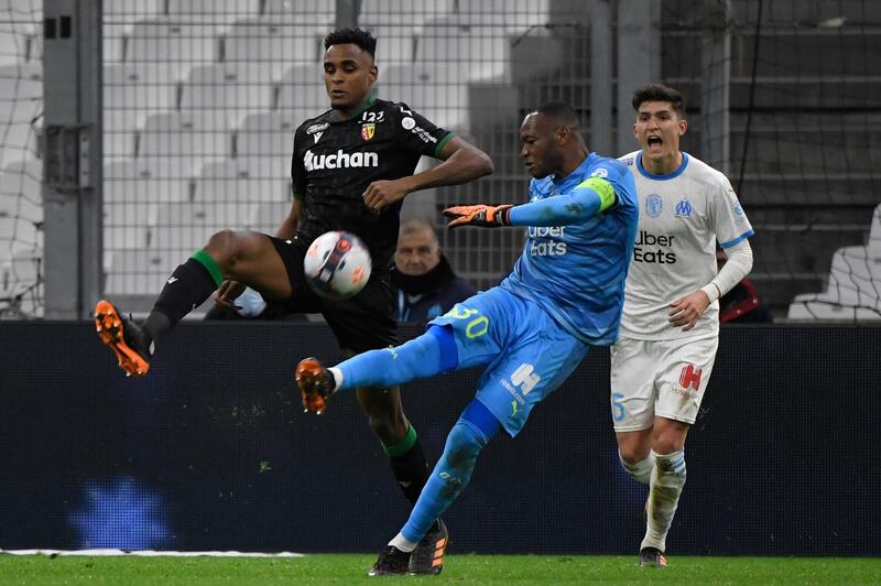 Marseille goalkeeper Steve Mandanda is fouled by Lens' Cheick Doucoure. AFP