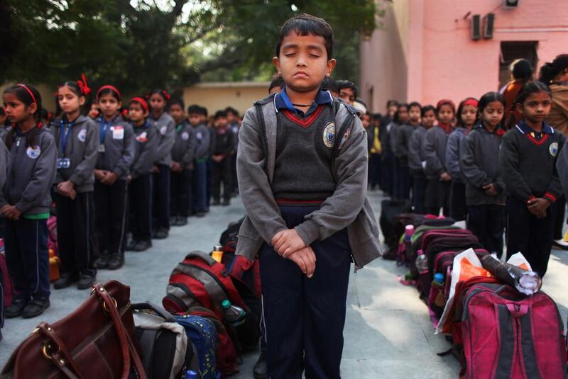 Schoolchildren in New Delhi observe a two-minute silence for victims killed in a Taliban attack on a military-run school in Peshawar, yesterday. Altaf Qadri / AP Photo