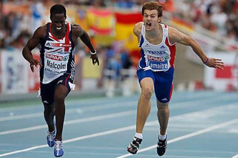 France's Christophe Lemaitre, right, crosses the finish line a fraction ahead of Britain's Christian Malcolm in the 200 metres last night.