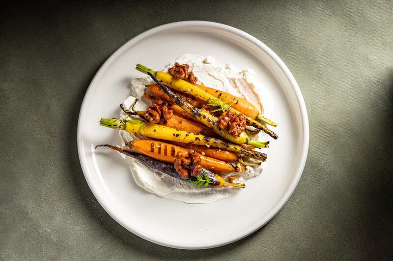 Rainbow heirloom carrots with smoked labneh, soy honey butter, candied walnuts and fermented black garlic.  