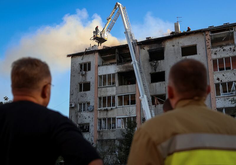 Rescuers at the site of a block of flats in Lviv destroyed by Russian missiles on Tuesday. Reuters