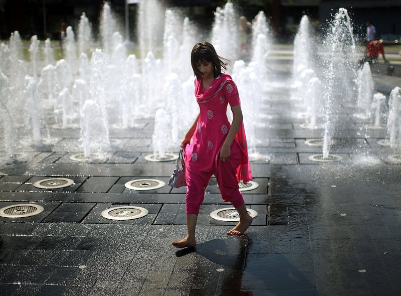 A student cools off in the fountains of Piccadilly Gardens in  Manchester, in 2009.