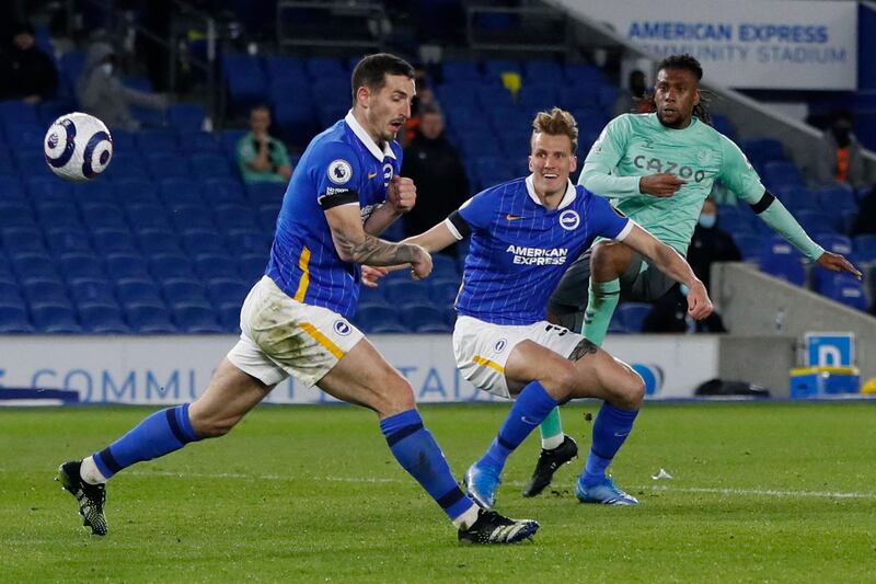 Everton's Nigerian midfielder Alex Iwobi (R) shoots on goal during the English Premier League football match between Brighton and Hove Albion and Everton at the American Express Community Stadium in Brighton, southern England on April 12, 2021. RESTRICTED TO EDITORIAL USE. No use with unauthorized audio, video, data, fixture lists, club/league logos or 'live' services. Online in-match use limited to 120 images. An additional 40 images may be used in extra time. No video emulation. Social media in-match use limited to 120 images. An additional 40 images may be used in extra time. No use in betting publications, games or single club/league/player publications.
 / AFP / POOL / PAUL CHILDS / RESTRICTED TO EDITORIAL USE. No use with unauthorized audio, video, data, fixture lists, club/league logos or 'live' services. Online in-match use limited to 120 images. An additional 40 images may be used in extra time. No video emulation. Social media in-match use limited to 120 images. An additional 40 images may be used in extra time. No use in betting publications, games or single club/league/player publications.
