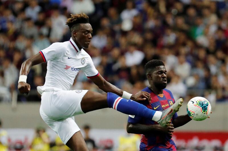 Chelsea's Tammy Abraham in action with Barcelona's Samuel Umtiti. Reuters