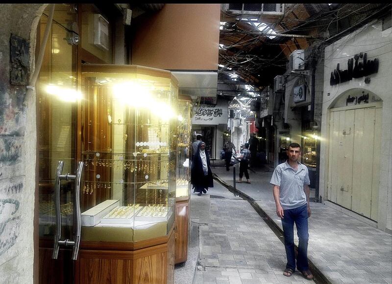 July 7, 2014: A man walking in the same market, nearly a month after ISIL militants took over the country’s second largest city. AP Photo