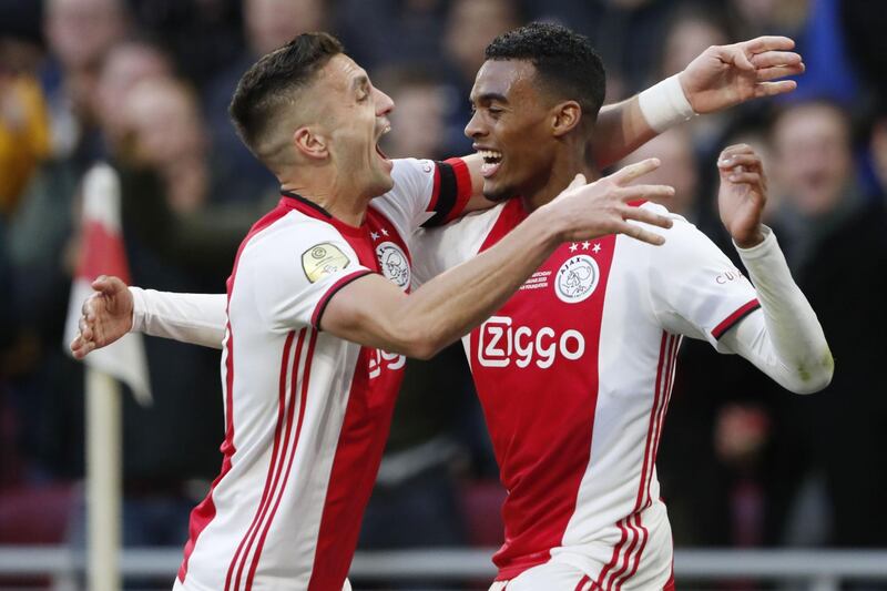 Ajax Amsterdam's Ryan Gravenberch (R) is congratulated by teammate Dusan Tadic during the Dutch Eredivisie football match in Amsterdam, on January 19, 2020. Netherlands OUT
 / AFP / ANP / Maurice van STEEN
