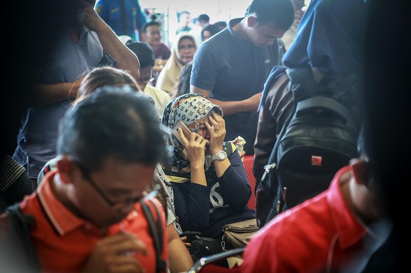 Family members react at Pangkal Pinang airport. AFP