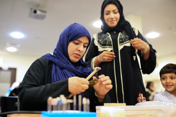 SHARJAH, UAE. March 5, 2014 - Azza Al Qubaisi (blue headscarf), founder of Back2Burqa, teaches an Islamic jewelry making class offered at the Sharjah Museum of Islamic Civilization in Sharjah, March 5, 2014. (Photo by: Sarah Dea/The National, Story by: Rym Ghazal)
