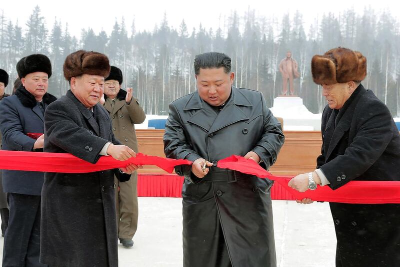 North Korean leader Kim Jong Un (2nd R) cutting a ribbon to mark the completion of the construction of the township of Samjiyon County. AFP