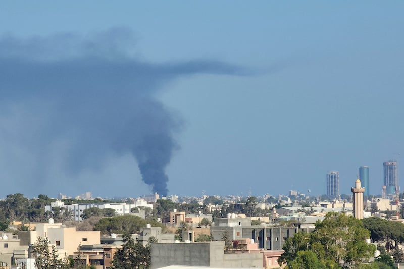 Smoke rises above Tripoli, Libya, on Tuesday amid clashes between armed groups affiliated with the Government of National Unity. AFP