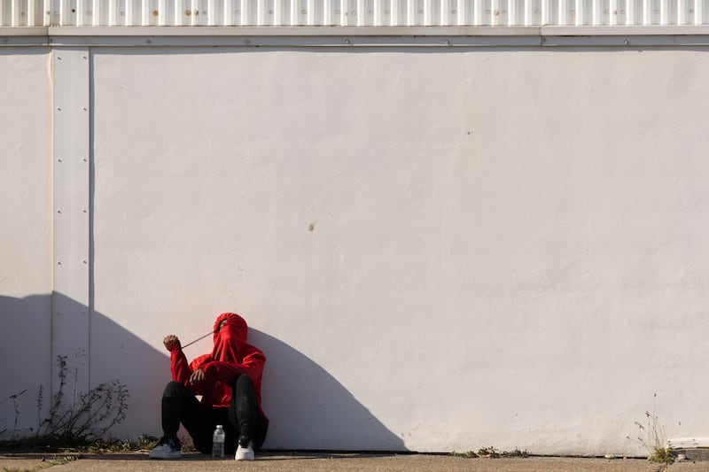 A migrant man waits to be processed by the UK Border Force, after arriving on Dungeness beach. Getty Images