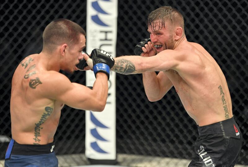 ABU DHABI, UNITED ARAB EMIRATES - JULY 16: (R-L) Tim Elliott punches Ryan Benoit in their flyweight fight during the UFC Fight Night event inside Flash Forum on UFC Fight Island on July 16, 2020 in Yas Island, Abu Dhabi, United Arab Emirates. (Photo by Jeff Bottari/Zuffa LLC via Getty Images)