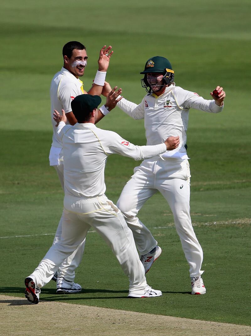 ABU DHABI, UNITED ARAB EMIRATES - OCTOBER 16:  Mitchell Starc and Marnus Labuschagne  of Australia celebrates the wicket of Mohammad Hafeez of Pakistan during day one of the Second Test match between Australia and Pakistan at Sheikh Zayed stadium on October 16, 2018 in Abu Dhabi, United Arab Emirates.  (Photo by Francois Nel/Getty Images)