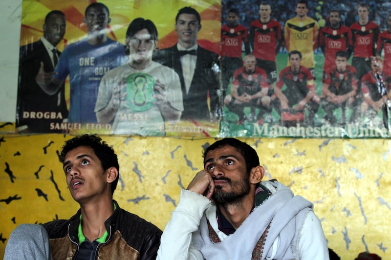epa07278265 Yemenis watch a television broadcasting of the 2019 AFC Asian Cup group D soccer match between Yemen and Iraq, in Sanaâ€™a, Yemen, 12 January 2019.  EPA/YAHYA ARHAB