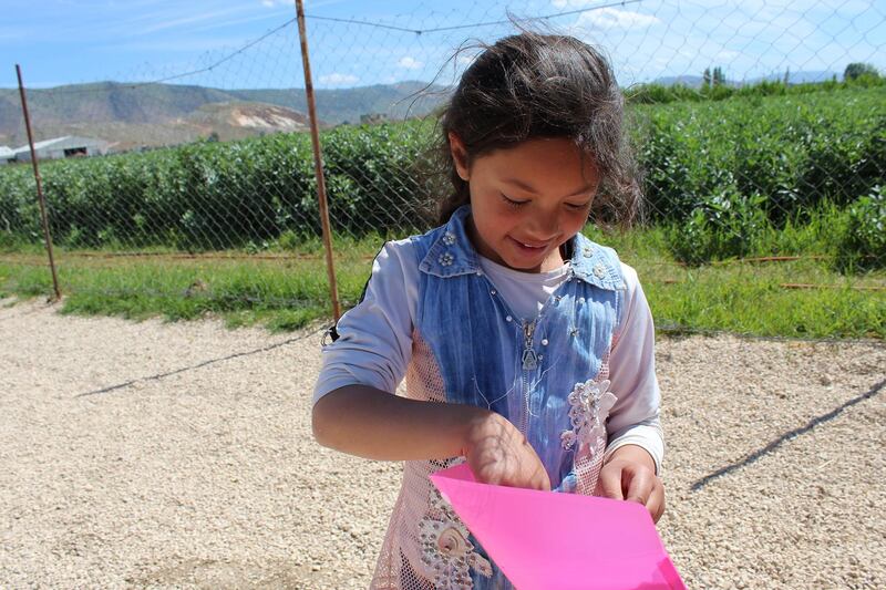 A pupil receives her weekly homework in Bekaa Valley, Lebanon. Hands Up supports a school in Lebanon’s Bekaa Valley for 300 Syrian refugee children.Courtesy Hands Up Foundation