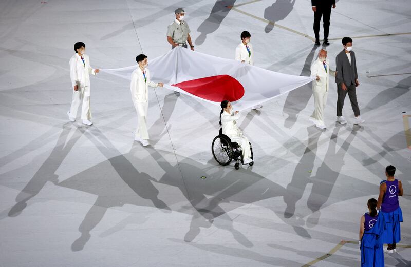 Healthcare workers present the Japanese flag. Reuters