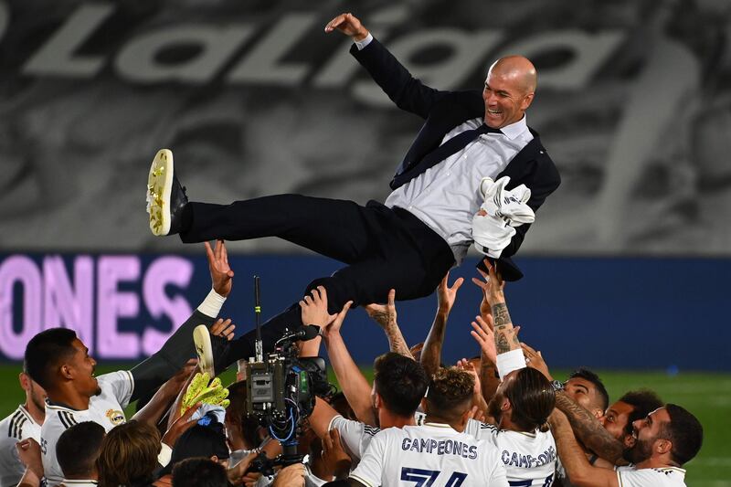 Real Madrid's player lift manager Zinedine Zidane after winning the La Liga title following their win over Villarreal at the Alfredo Di Stefano Stadium on Thursday. AFP