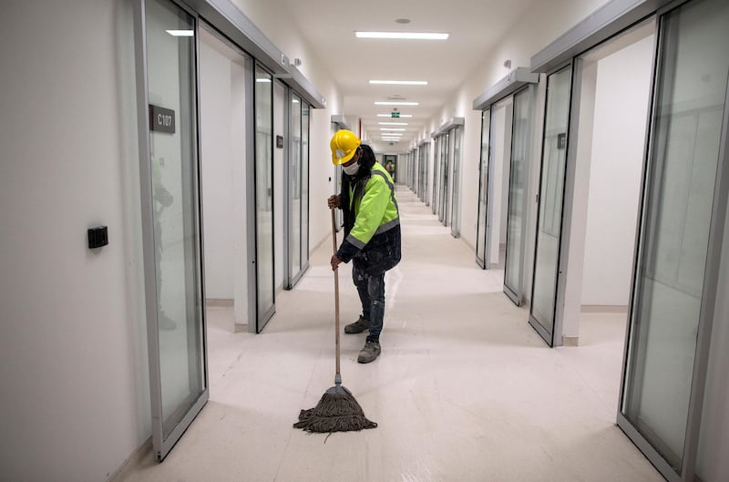A worker cleans the corridor at the intensive care unit at a temporary hospital being built at the Ataturk Airport, in Istanbul, Turkey.  EPA