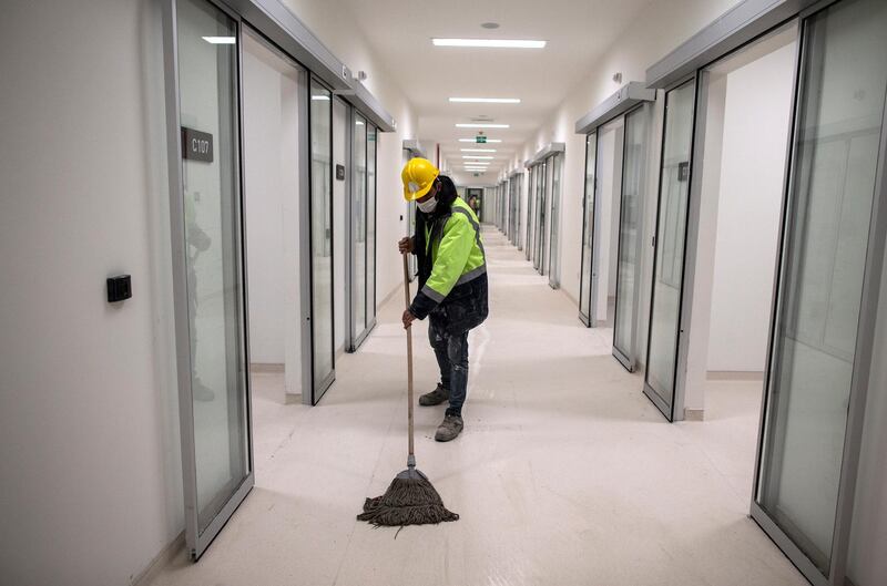 A worker cleans the corridor at the intensive care unit at a temporary hospital being built at the Ataturk Airport, in Istanbul, Turkey.  EPA