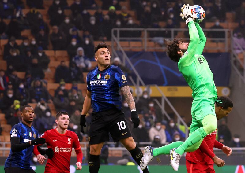 Liverpool keeper Alisson Becker collects a high ball watched by Inter's Lautaro Martinez. EPA