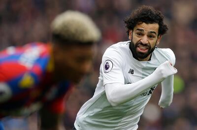 Liverpool's Mohamed Salah runs past Crystal Palace's James Tomkins during the English Premier League soccer match between Crystal Palace and Liverpool at Selhurst Park stadium in London, Saturday, March 31, 2018. Liverpool won the game 2-1. (AP Photo/Alastair Grant)