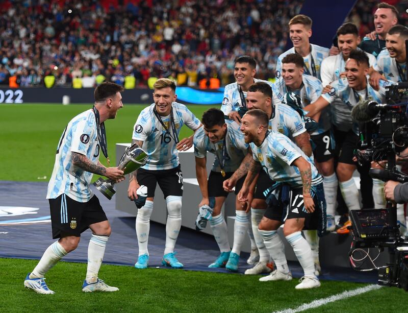 Lionel Messi celebrates with the trophy. EPA