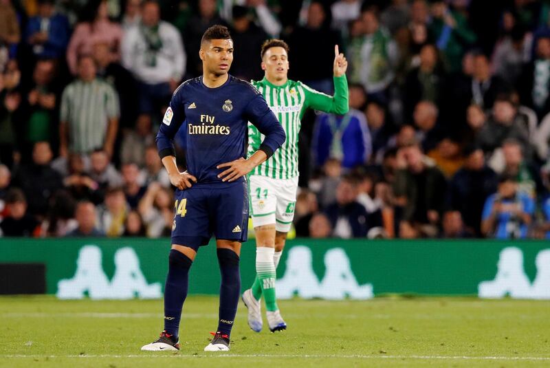 Real Madrid midfielder Casemiro reacts as Cristian Tello celebrates scoring Real Betis' second goal. Reuters