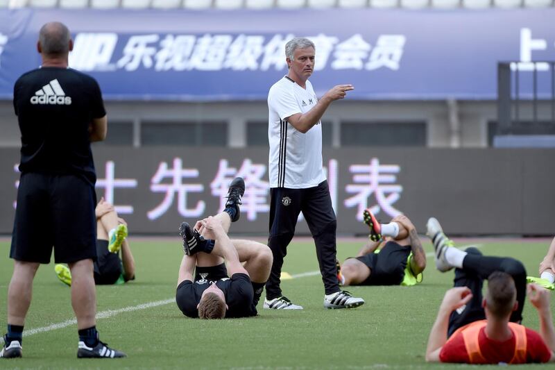 Manchester United's head coach Jose Mourinho (C) takes part in a training session with teammates ahead of the 2016 International Champions Cup football match between Manchester United and Dortmund in Shanghai on July 21, 2016. / AFP PHOTO / WANG ZHAO