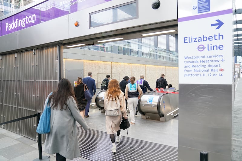 Passengers travel down to the Elizabeth line platforms at Paddington Station. PA