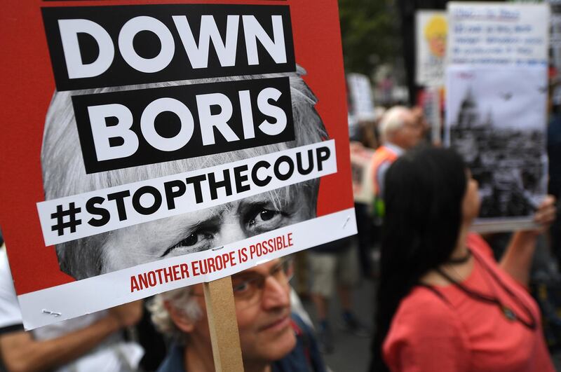 epa07825827 People protest against the government of British Prime Minister Boris Johnson, in London, Britain, 07 September 2019. The event 'Demand Democracy: Johnson Out! #StopTheCoup' calls for the resignation of British Prime Minister Boris Johnson and an end to his Brexit agenda.  EPA/ANDY RAIN