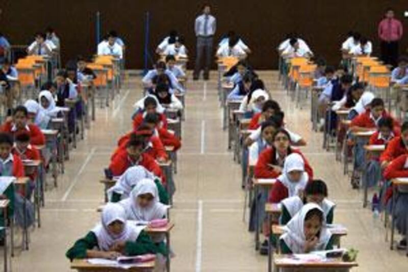 Students answer a paper of the CBSE exam in the auditorium of the Abu Dhabi Indian School on March 4 2009.