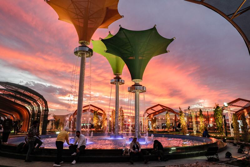 A fountain in the green zone at the International Convention Centre at sunset. AFP