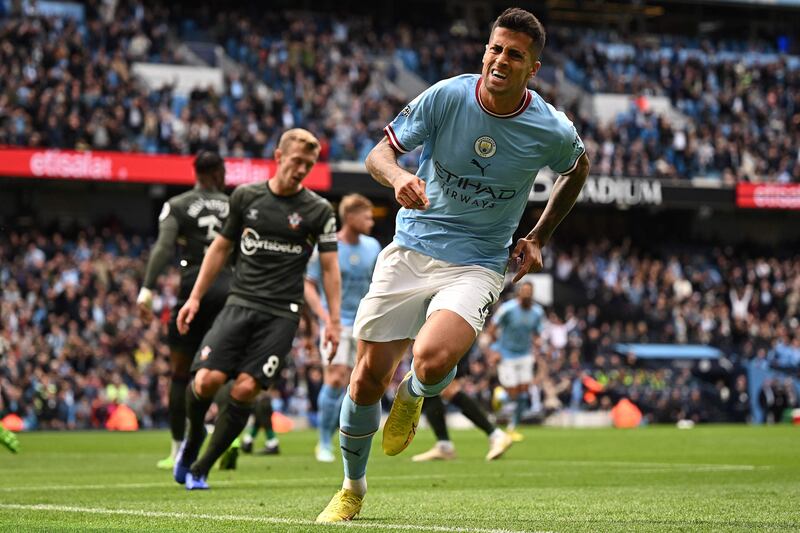 Manchester City's Portuguese defender Joao Cancelo celebrates scoring the opening goal during the English Premier League football match between Manchester City and Southampton at the Etihad Stadium in Manchester, north west England, on October 8, 2022.  (Photo by Oli SCARFF / AFP) / RESTRICTED TO EDITORIAL USE.  No use with unauthorized audio, video, data, fixture lists, club/league logos or 'live' services.  Online in-match use limited to 120 images.  An additional 40 images may be used in extra time.  No video emulation.  Social media in-match use limited to 120 images.  An additional 40 images may be used in extra time.  No use in betting publications, games or single club/league/player publications.   /  