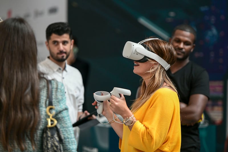 A visitor tests a virtual reality headset at the Dubai Metaverse Assembly at Museum of Future.