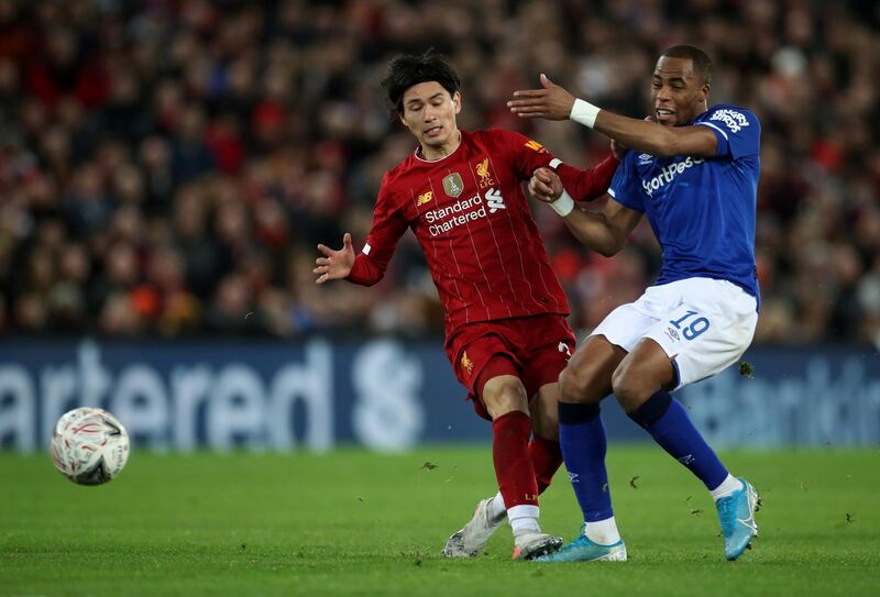 Everton's Djibril Sidibe tackles Liverpool's Takumi Minamino. Reuters