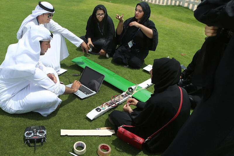 Al Ain College students discuss the way forward with their creation. Delores Johnson / The National