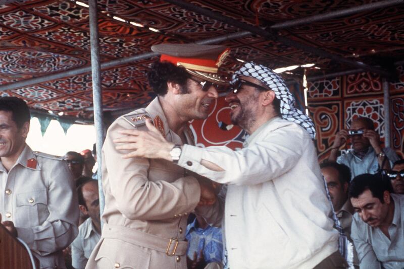 Palestinian PLO leader Yasser Arafat (R) kisses Libyan leader Colonel Mouammar Kadhafi (L) during a parade, 26 August 1978 in Tripoli, Libya.