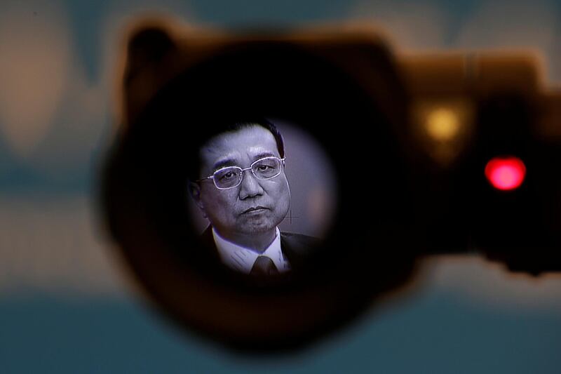 Chinese premier Li Keqiang is seen on a camera viewfinder at the Great Hall of the People in Beijing. Jason Lee / Reuters