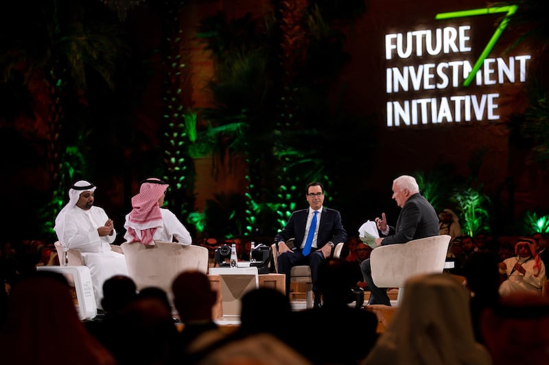 Sheikh Salman bin Khalifa Al Khalifa, Bahrain's Finance Minister, left, and Mr Mnuchin, second right, during a panel session. Bloomberg