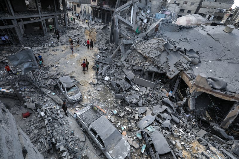 Palestinians assess damage in Gaza city. EPA
