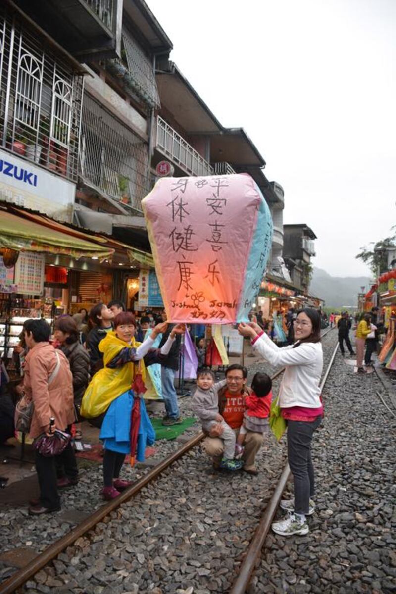 A family sends off a lantern from the village of Pinxi, near Taipei. Photo by Rosemary Behan