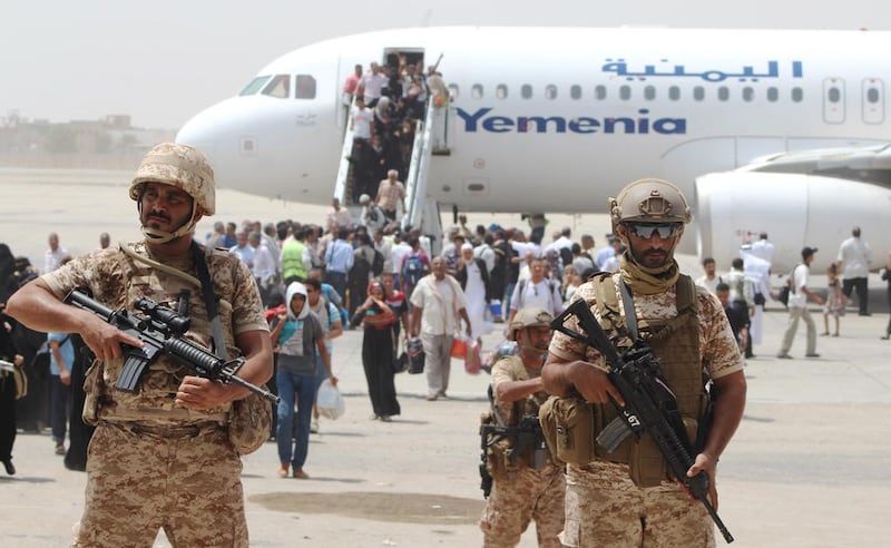 Security stands guard as passengers disembark in August 2015. Yemenia is seeking to resume flights to the Arabian Gulf and Africa. AFP