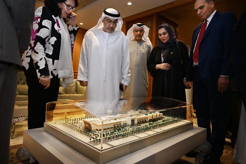 Abdulrahman Al Owais, chairman of the board of trustees of the Sheikh Zayed Grand Mosque Centre, and Hayat Al Qarmazi, Tunisia's Minister of Cultural Affairs, look at a model of the renovation plans. Wam
