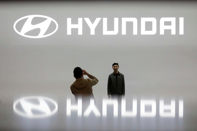 FILE PHOTO: Visitors take photographs in front of the logo of Hyundai Motor during the 2019 Seoul Motor Show in Goyang, South Korea, March 28, 2019. REUTERS/Kim Hong-Ji/File Photo