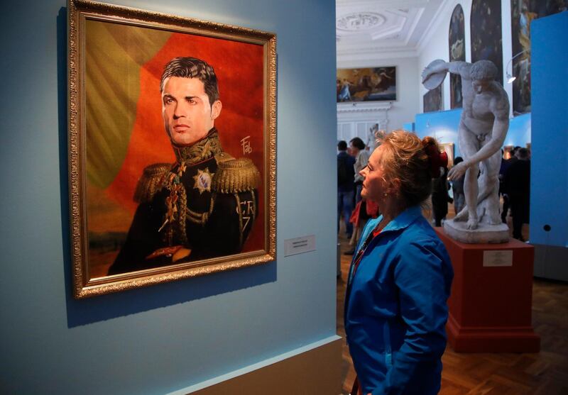 A visitor examines a portrait of Portugal's Cristiano Ronaldo at the Museum of Academy of Arts in St.Petersburg, Russia. Dmitri Lovetsky / AP Photo