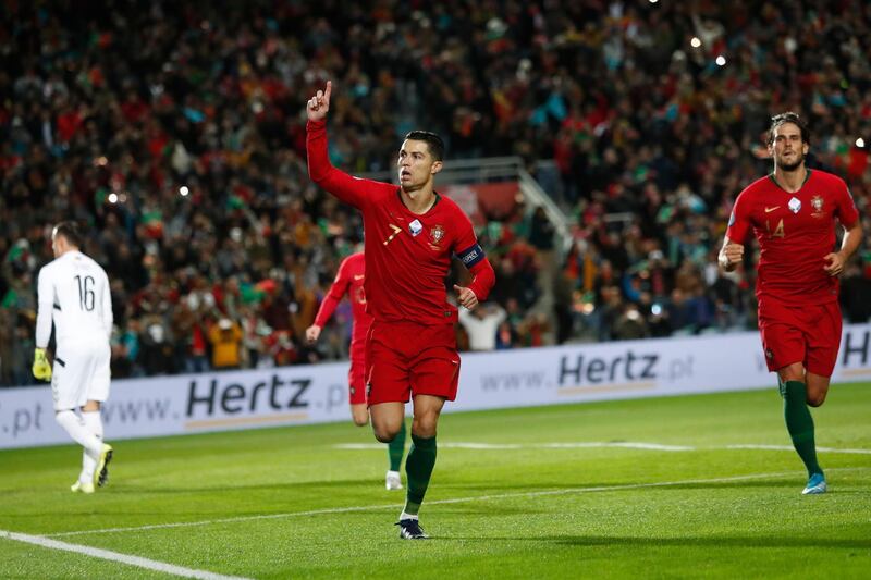 Cristiano Ronaldo, center, celebrates after scoring the opening goal against Lithuania in Faro. AP