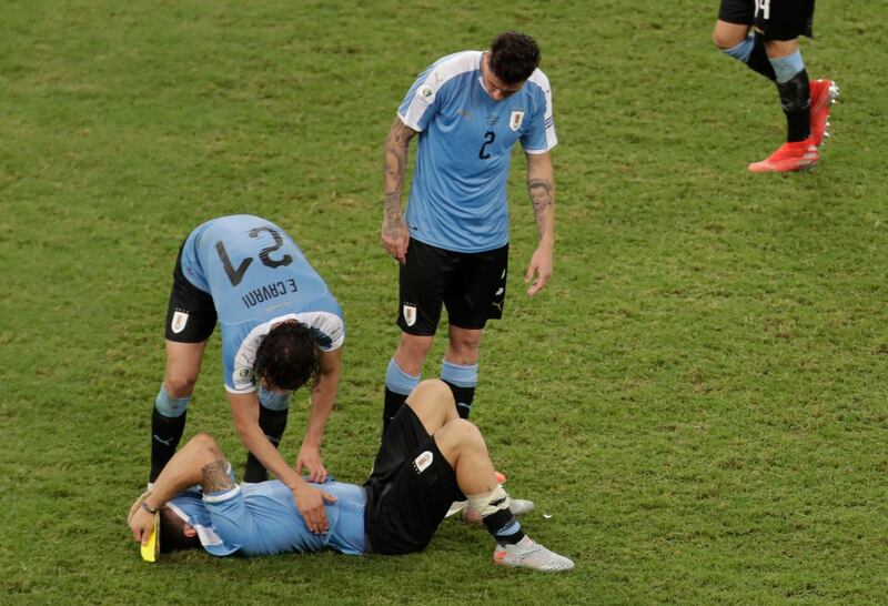 Uruguay players console Luis Suarez after the Copa America defeat to Peru. AP Photo