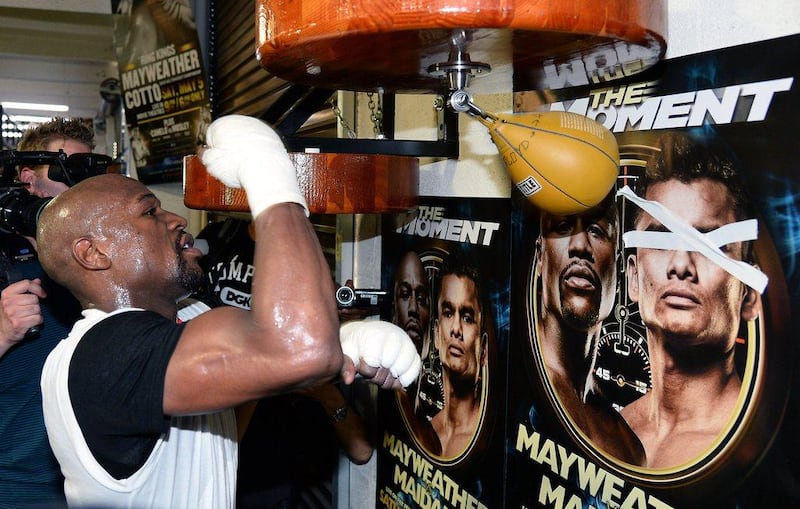 Floyd Mayweather punches the bag at the Mayweather Boxing Club on Tuesday. Ethan Miller / Getty Images / AFP / April 22, 2014